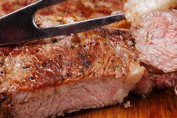 grilled beef steak on a cutting board, close-up