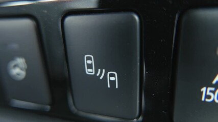 Switching on the blind spot monitoring of a car to ensure the safety of its occupants. The car with blind spot monitor which detects other vehicles on the side.