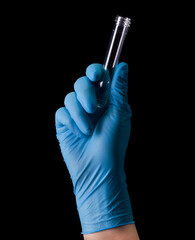 Doctor's hand in medical gloves holding test tube with coronavirus COVID-19
