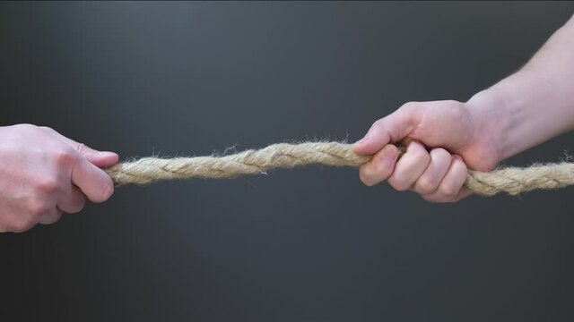 Two hand pull the rope on black background
