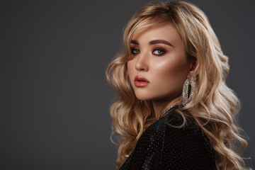 Fototapeta premium Beautiful model, woman with hollywood waves hairstyle, smokey eyes makeup, wearing trendy earrings with rhinestones. Close up studio portrait. Copy, empty space for text