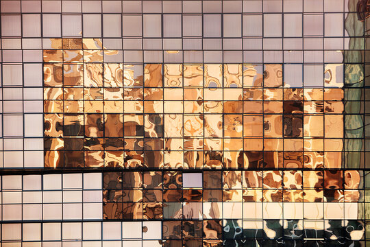 Buildings reflected in the windows of a modern office building in Dubai