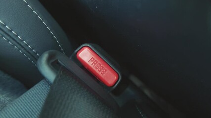 Closeup of the car seat being buckled up for safety during driving