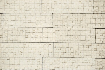 decorative yellow and white brick wall, plaster and light background, building wall