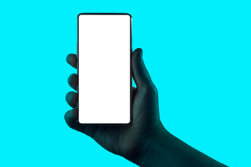 Hand holding phone. Silhouette of male hand holding smartphone isolated on aqua blue background....