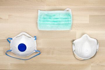 Different medical masks isolated on a flat surface