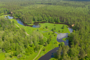 Flying above river in deep green forest, Moscow area, Russia