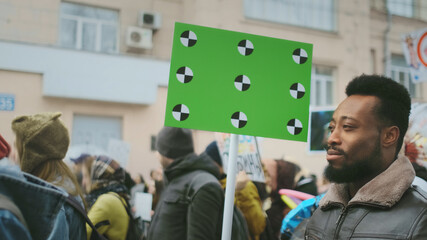 African american man hold banner in hand mock-up. Track point. Blank placard board. Empty poster. Crowd people demonstration. Afro rebel go walk. Revolution in city street. Political rally fight 4k.