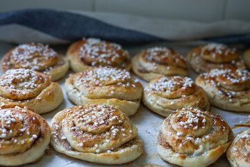 Batch of freshly baked homemade Swedish style cinnamon rolls / buns with pearl sugar -Image