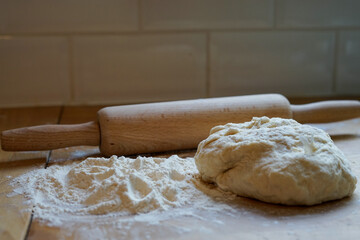 Concept - Baking Bread. Rolling pin, dough, and flour on a wooden surface. London, UK -Image