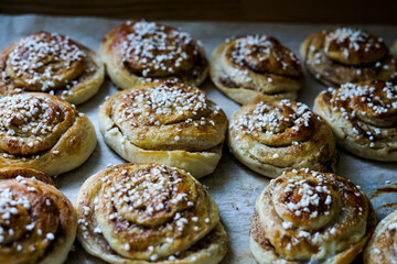 Batch of freshly baked homemade Swedish style cinnamon rolls / buns with pearl sugar -Image