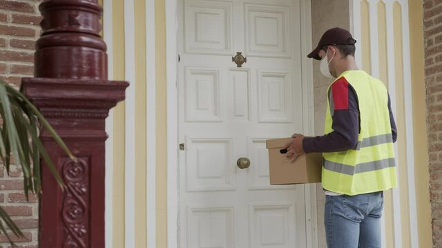 The courier delivers parcel at home. Delivery in quarantine