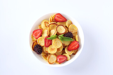 Trendy tiny pancakes for breakfast with strawberry, blackberry and mint in bowl on white background, View from above