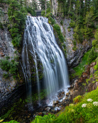 Large waterfall cascading down in the mountains.  Mount Rainier National Park