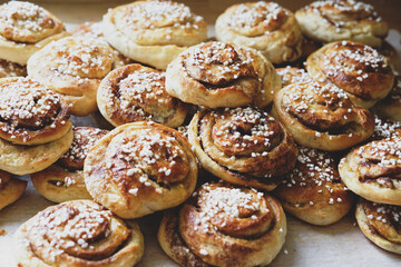 Batch of freshly baked homemade Swedish style cinnamon rolls / buns with pearl sugar -Image