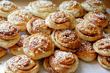 Batch of freshly baked homemade Swedish style cinnamon rolls / buns with pearl sugar -Image