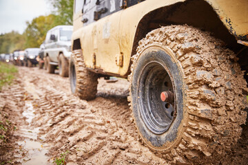 Fototapeta na wymiar dirty off-road car tire in mud close-up