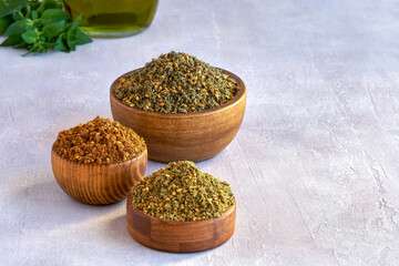 Mixed spice zaatar or zatar in wooden bowls, Various type of zaatar blend. Close up with copy space	