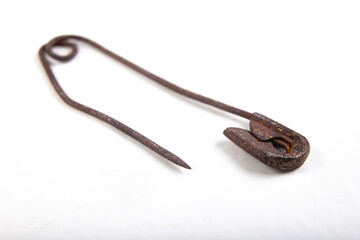 Old rusty safety pin for tailoring work. Accessories needed for sewing in a sewing room.