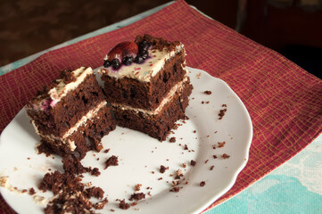 Sponge cake with cream on a white plate.