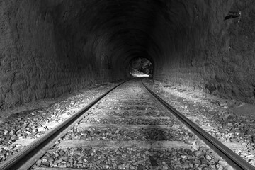 dark tunnel with train tracks
