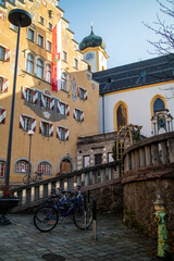 Obraz premium Facade of ancient historical traditional house with town flag in Kufstein city, Austria.