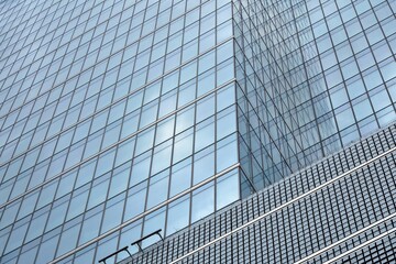 Facade texture of a glass mirrored office building. Fragment of the facade. Modern architecture of the office building.