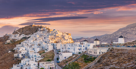 The chora - capital with traditional white houses of Serifos island Aegean Cyclades Greece against a dramatic sky on sunset on summer