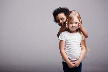 Curly-skinned black boy covered his girlfriend's ears so that she would not listen about racism in the world