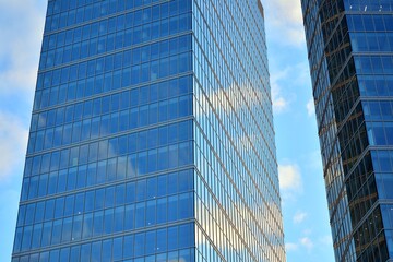 Facade texture of a glass mirrored office building. Fragment of the facade. Modern architecture of the office building.