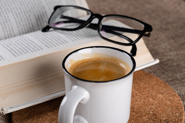 cup of coffee with book and glasses
