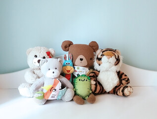 Teddy bears, toy tigers and a donkey on the cupboard in the nursery