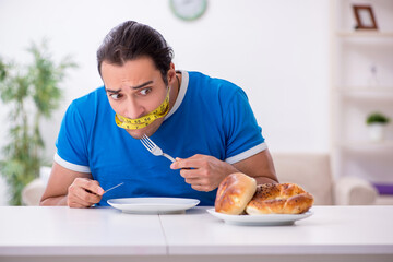 Young hungry man in dieting concept