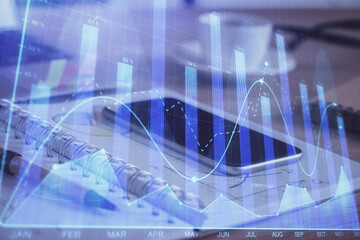 Double exposure of forex chart drawing and cell phone background. Concept of financial data analysis