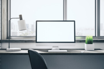 Contemporary desktop with empty white computer screen