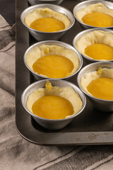 Naklejka na ściany i meble Traditional portuguese dessert pastel de nata before going to the oven. Dough of custard egg tarts