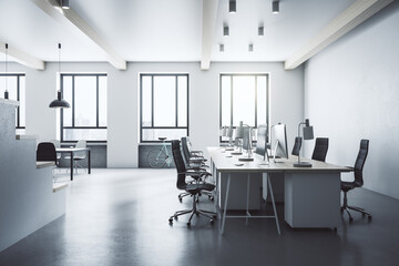 Modern coworking loft interior with furniture and daylight.