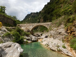 Fototapeta na wymiar Stone bridge in mountains in the Nervia Valley