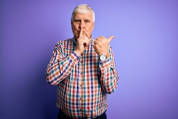 Senior handsome hoary man wearing casual colorful shirt over isolated purple background asking to be quiet with finger on lips pointing with hand to the side. Silence and secret concept.