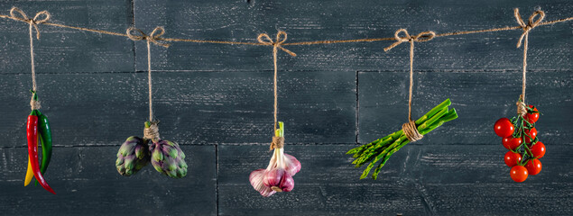 panorama of fresh vegetables and spices on wooden background