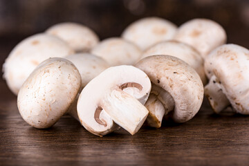 Selective focus Cut mushroom champignon on the background of whole mushrooms.