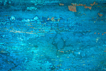 Old crackled teal turquoise painted wood surface. Vintage wooden wall or floor with cracked paint.