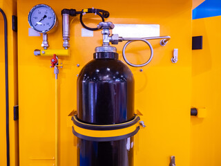 Obraz premium Black ballon for gas storage. Concept - ballon for air supply. Ballon is mounted next to pressure sensor. Concept - sensor shows gas pressure. Industrial equipment. Cylinder black. Chemical equipment