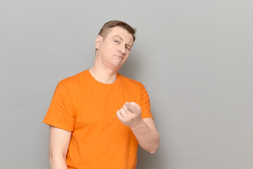 Portrait of funny serious man pointing with index finger at you