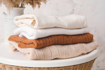 Stack of clean clothes on table in room