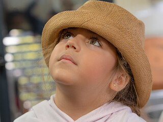 Little girl with hat looking up