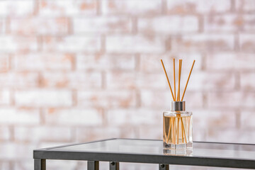 Reed diffuser on table in room