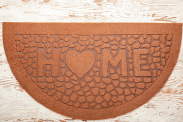 Door mat on wooden background