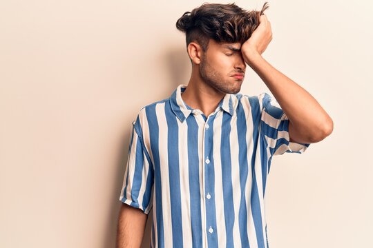 Young hispanic man wearing casual clothes surprised with hand on head for mistake, remember error. forgot, bad memory concept.