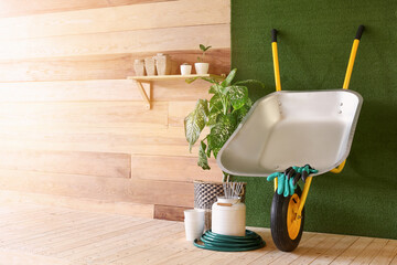 Set of gardening supplies near wooden wall